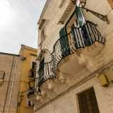 Il particolare ballatoio � sorretto da massicci mensoloni al secondo dei tre livelli che compongono la bianca facciata